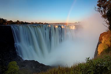 A rainbow at sunset over the Victoria Falls.