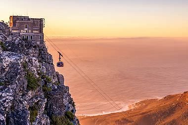 The sun sets over the Table Mountain cableway.