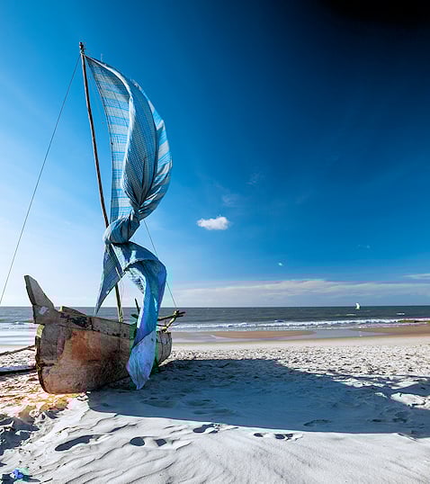 Traditional dhow boat on a tropical beach in Mozambique