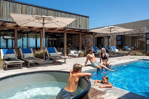 Family relaxing around a pool.