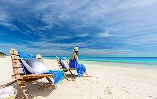 Woman relaxing on a beach chair along Mozambique’s tropical coast