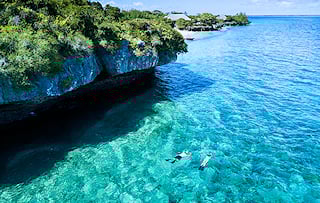Snorkelers in clear waters near an island in the Quirimbas Archipelago, Mozambique