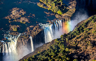 Rainbow arching over Victoria Falls in southern Zambia